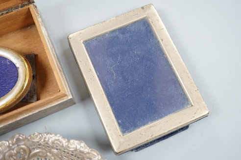 A silver mounted cigarette box, a silver bonbon dish and two photo graph frames including silver.